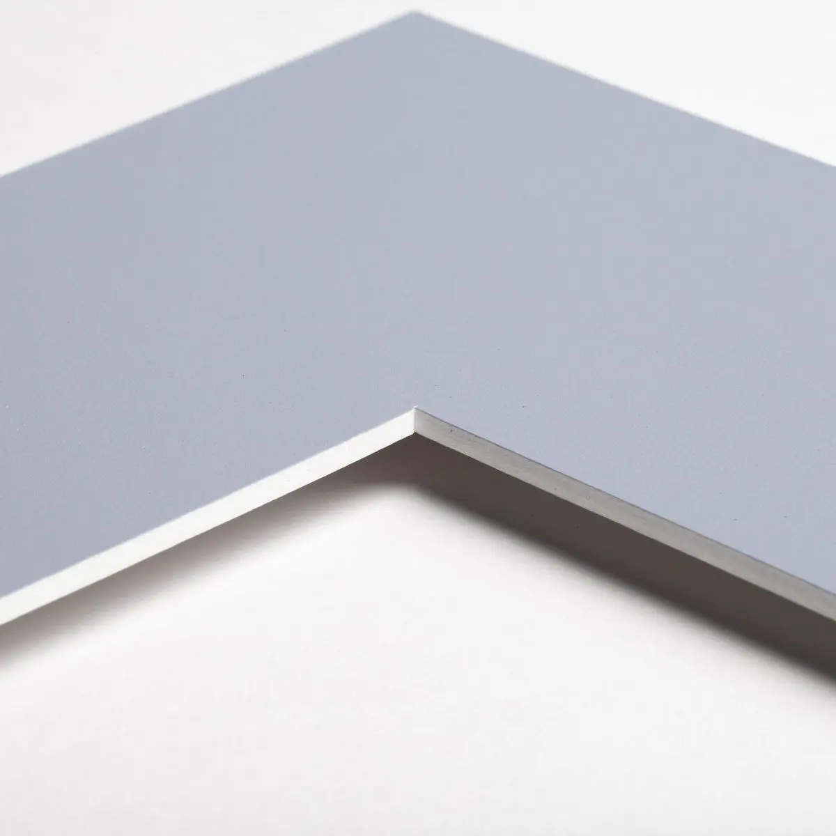 Découvre un aperçu détaillé du coin de ton passe-partout de qualité supérieure chez MonCadrePréféré, disponible en bleu ciel.