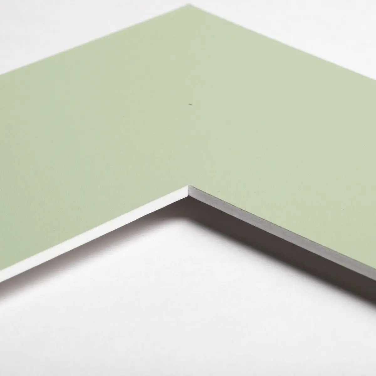 Découvre le coin d'un échantillon de passe-partout Vert Mousse, idéal pour ton prochain encadrement chez MonCadrePréféré.